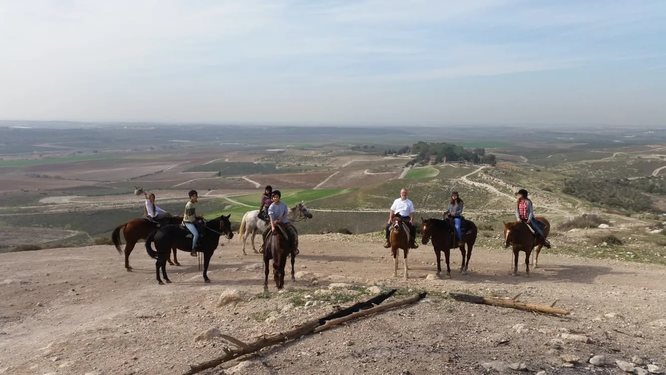 A group on horseback in an open landscape